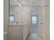 Bright bathroom featuring a double sink vanity, large mirror, and tile flooring at 345 Sedgewick Dr, Davenport, FL 33837
