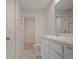 Bathroom featuring dual sinks, toilet, and access to a closet with wire shelving at 345 Sedgewick Dr, Davenport, FL 33837