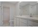 Bathroom featuring dual sinks, a toilet, and access to a closet with wire shelving at 345 Sedgewick Dr, Davenport, FL 33837