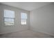 Cozy bedroom filled with natural light from two windows with views of the outdoors at 345 Sedgewick Dr, Davenport, FL 33837