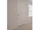 Simple bedroom featuring carpet flooring, baseboards, and a white paneled door at 345 Sedgewick Dr, Davenport, FL 33837