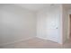Bright bedroom with neutral carpet, white walls and baseboards, a standard white door at 345 Sedgewick Dr, Davenport, FL 33837