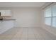 Bright dining area with tile floors, natural light from the large window and a breakfast bar looking into the kitchen at 345 Sedgewick Dr, Davenport, FL 33837