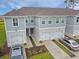 Inviting townhomes boast attached garages, manicured front yards, and a modern exterior design at 345 Sedgewick Dr, Davenport, FL 33837