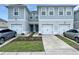 Charming townhome with attached garages, tidy landscaping, and neutral gray toned exterior paint scheme at 345 Sedgewick Dr, Davenport, FL 33837
