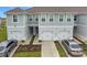 Charming townhomes featuring well-maintained lawns, gray siding, and convenient attached one-car garages at 345 Sedgewick Dr, Davenport, FL 33837