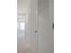 Hallway with carpet, white trim and doors including a door with louvers for ventilation at 345 Sedgewick Dr, Davenport, FL 33837