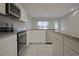 Modern kitchen featuring stainless steel appliances, sleek countertops, and ample cabinet space at 345 Sedgewick Dr, Davenport, FL 33837