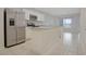 Bright kitchen featuring white cabinetry, stainless steel appliances, and a spacious center island at 345 Sedgewick Dr, Davenport, FL 33837