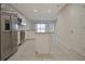 Well-lit kitchen featuring stainless steel appliances, a center island, and open access to the living area at 345 Sedgewick Dr, Davenport, FL 33837