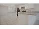 Modern kitchen showcasing an island with stone countertop, stainless steel appliances, and white cabinets at 345 Sedgewick Dr, Davenport, FL 33837