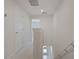 Upstairs hallway with carpet and a view down to the entry of the home at 345 Sedgewick Dr, Davenport, FL 33837
