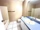 Bathroom with a tub, vanity with sink, and coordinated tile flooring at 401 Talquin Ct, Orlando, FL 32807