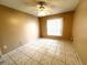 Cozy bedroom with a ceiling fan, tile floors, and a window creating a comfortable atmosphere at 401 Talquin Ct, Orlando, FL 32807