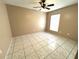 Bedroom with neutral walls, tile flooring, and ceiling fan with a window for natural light at 401 Talquin Ct, Orlando, FL 32807
