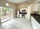Bright kitchen with stainless steel appliances and access to the backyard through sliding doors at 401 Talquin Ct, Orlando, FL 32807