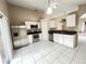 Kitchen features stainless steel appliances, white cabinets, and tile flooring at 401 Talquin Ct, Orlando, FL 32807
