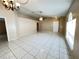 Open living room features tile flooring, ceiling fan, and lots of natural light at 401 Talquin Ct, Orlando, FL 32807