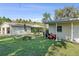 A spacious backyard offering lots of green space, a shed and a patio at 401 Woodlawn Ter, Kissimmee, FL 34744