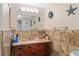 Bathroom features a vanity with a sink, a tiled backsplash, and decorative art on the wall at 401 Woodlawn Ter, Kissimmee, FL 34744