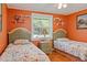 Nicely decorated bedroom features two twin beds and a window that brings in natural light at 401 Woodlawn Ter, Kissimmee, FL 34744