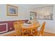 Cozy dining area features a wood table, chairs, and natural light from the window at 401 Woodlawn Ter, Kissimmee, FL 34744