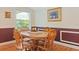 Cozy dining area features a wood table, chairs, and natural light from the window at 401 Woodlawn Ter, Kissimmee, FL 34744