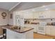 Well-equipped kitchen features white appliances, countertops, and cabinetry, offering a functional and classic culinary space at 401 Woodlawn Ter, Kissimmee, FL 34744