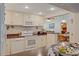 Well-equipped kitchen features white appliances, countertops, and cabinetry, offering a functional culinary space at 401 Woodlawn Ter, Kissimmee, FL 34744