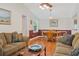 Cozy living room features comfortable seating, warm wood floors, and ample natural light at 401 Woodlawn Ter, Kissimmee, FL 34744