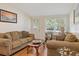 Comfortable living room features cozy seating, wood floors, and ample natural light at 401 Woodlawn Ter, Kissimmee, FL 34744