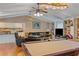 Bright living room showcases a billiard table, open layout connecting to the kitchen, and comfortable seating areas at 401 Woodlawn Ter, Kissimmee, FL 34744