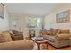 Comfortable living room features cozy seating, wood floors, and ample natural light at 401 Woodlawn Ter, Kissimmee, FL 34744