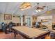 Bright living room showcases a billiard table, open layout connecting to the kitchen, and comfortable seating areas at 401 Woodlawn Ter, Kissimmee, FL 34744