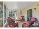 Screened-in patio featuring neutral tiled floors and wicker furniture perfect for relaxation at 401 Woodlawn Ter, Kissimmee, FL 34744