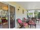 Screened-in patio with tiled floor and comfortable wicker chairs at 401 Woodlawn Ter, Kissimmee, FL 34744