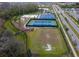 Aerial view of community amenities including tennis courts, basketball court, playground, and soccer field at 4211 Little Owl Ln, Kissimmee, FL 34746
