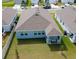 Aerial view of the back of a house shows a covered patio and a large lawn extending to the fence at 4211 Little Owl Ln, Kissimmee, FL 34746