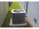 Efficient Carrier air conditioning unit with protective cage set along side of home on a concrete slab at 4211 Little Owl Ln, Kissimmee, FL 34746