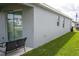 Backyard features a covered patio, lush green grass, and easy access to the house through sliding glass doors at 4211 Little Owl Ln, Kissimmee, FL 34746