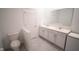 This bathroom features double sinks, a toilet, and a mirror at 4211 Little Owl Ln, Kissimmee, FL 34746