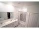 This bathroom features a double sink vanity, a standing shower, and a mirror at 4211 Little Owl Ln, Kissimmee, FL 34746