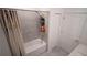 This bathroom has a tiled shower and tub with door to the closet and a curtain for privacy at 4211 Little Owl Ln, Kissimmee, FL 34746