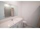 Bathroom vanity features a solid surface counter and sink with tile flooring at 4211 Little Owl Ln, Kissimmee, FL 34746