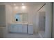 This bathroom features a double sink vanity, a standing shower, and a mirror at 4211 Little Owl Ln, Kissimmee, FL 34746