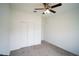 Bedroom with carpet flooring, a ceiling fan, and a double-door closet at 4211 Little Owl Ln, Kissimmee, FL 34746