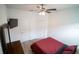 Bedroom with large dresser and TV mounted to the wall plus a ceiling fan for comfort at 4211 Little Owl Ln, Kissimmee, FL 34746