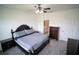 This bedroom features a ceiling fan, gray carpet, and adjacent bathroom at 4211 Little Owl Ln, Kissimmee, FL 34746