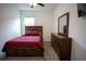 Comfortable bedroom with a window, ceiling fan, and carpet at 4211 Little Owl Ln, Kissimmee, FL 34746