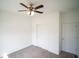 Bright bedroom with carpet flooring, a ceiling fan, and a double-door closet at 4211 Little Owl Ln, Kissimmee, FL 34746